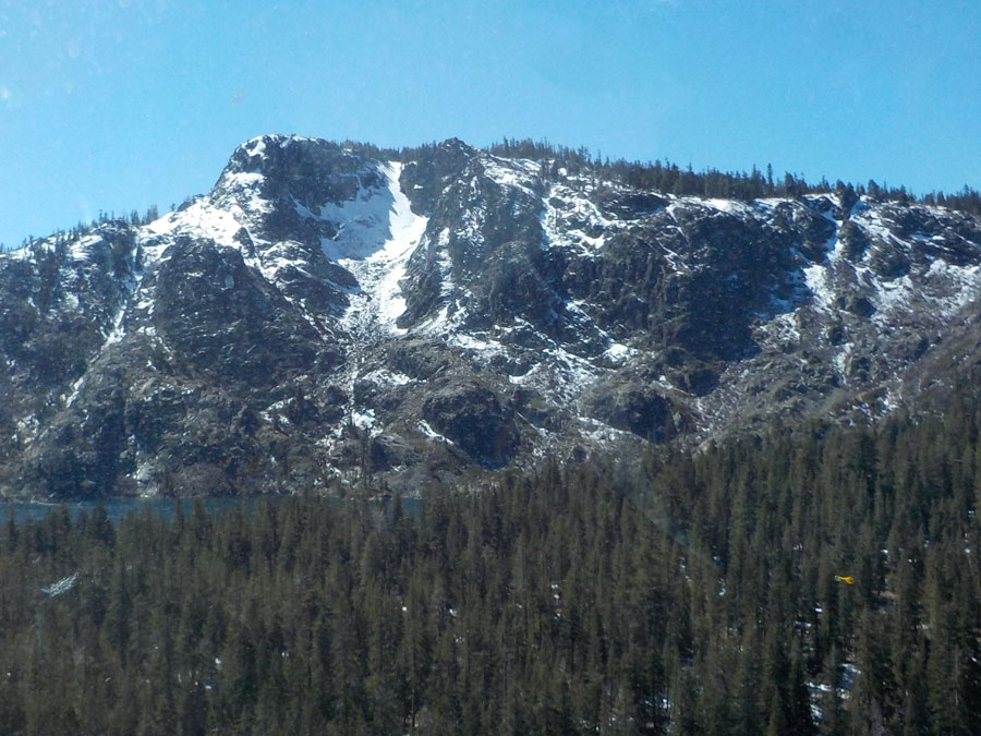 English Mountain rises above the forest, spotted with snow.