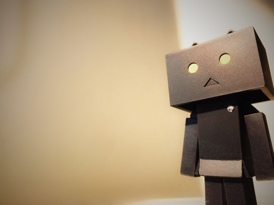 Boxy, brown, cardboard-looking robot with a big rectangular head.