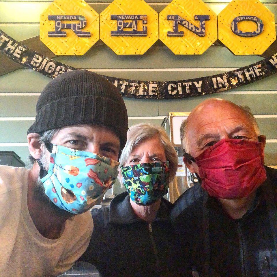 Aaron Foster, Wendy Ward, and Ken Ward are all wearing face masks as they look into the camera at Aaron’s restaurant, which is called food and drink.