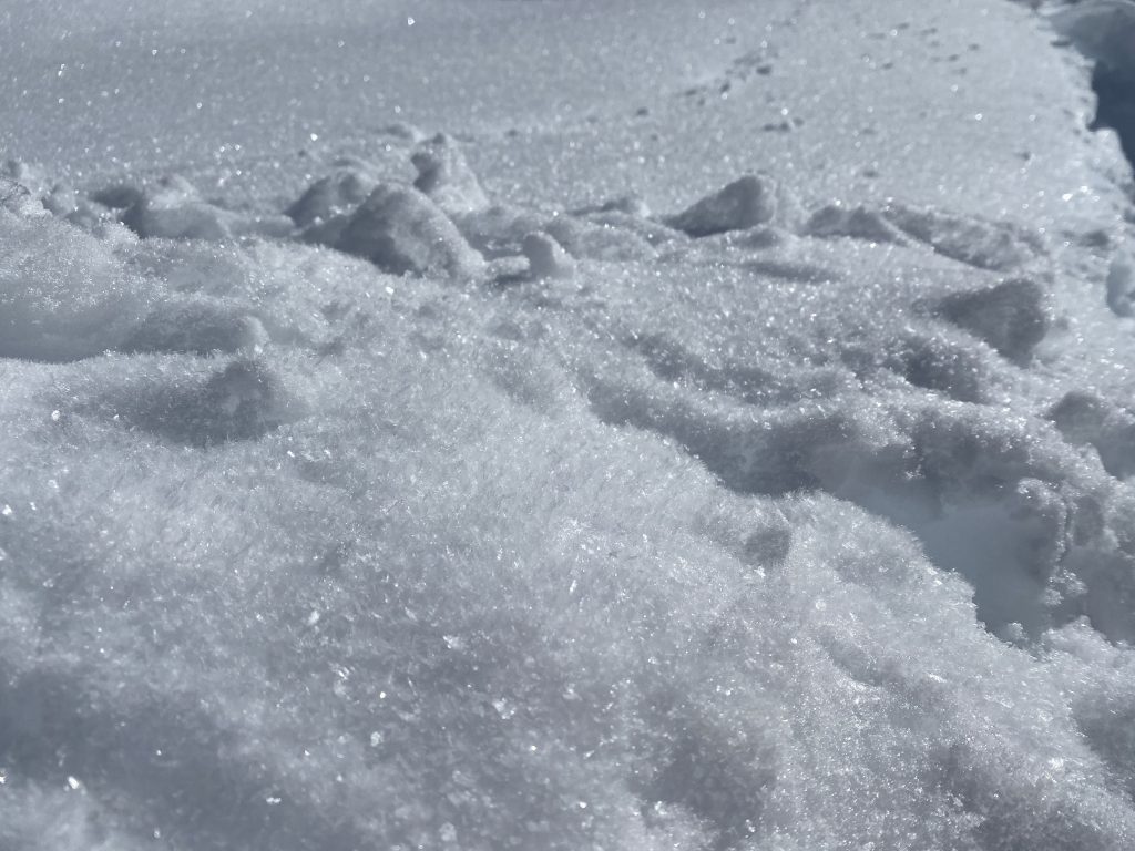 A close-up photo of snow crystals.