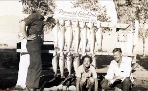 Several people pose next to the record catch of Lahontan cutthroat in 1934.
