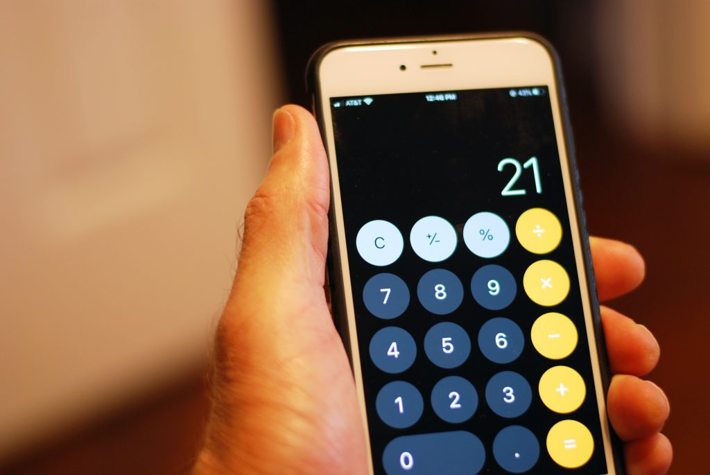 An iPhone displays the calculator app with the number 21 typed in.