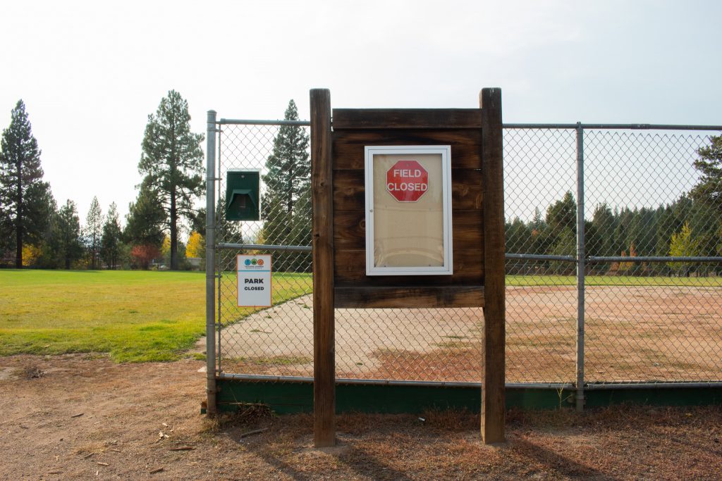 A "field closed" sign in front of the empty field of Glenshire Elementary School