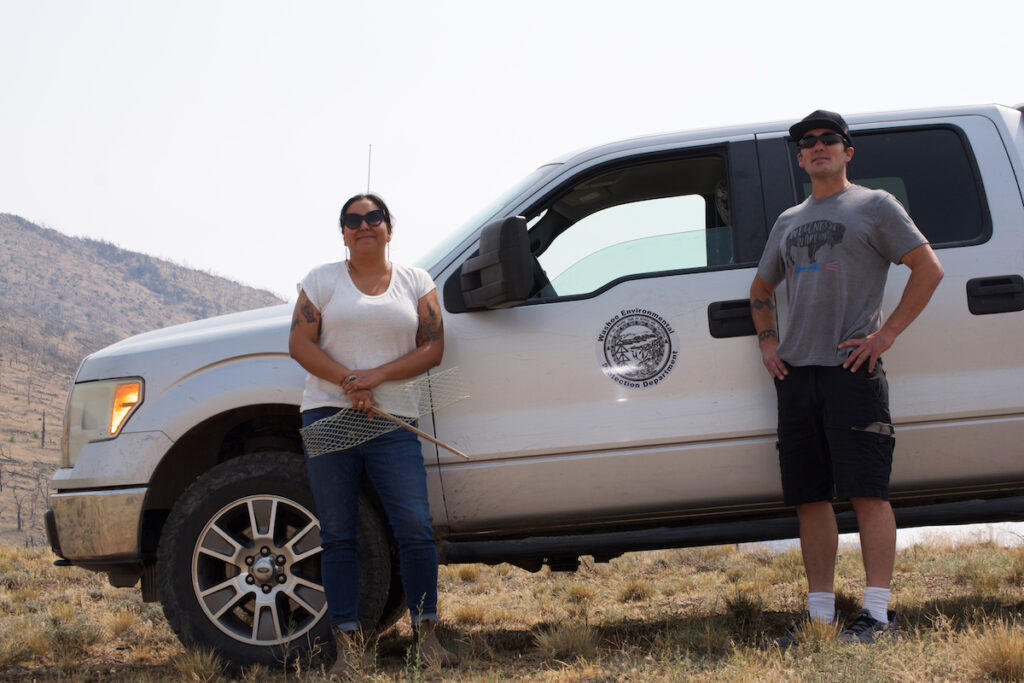 Rhiana Jones and Billy Hawk Enos stand near a truck in Pine Nut Mountains
