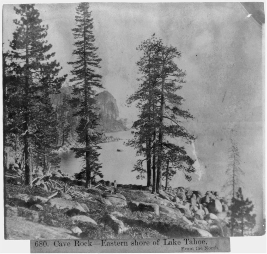 Historic image of cave rock framed by large pine trees