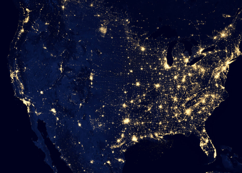 satellite image of US from space at night shows bright lights in metropolitan areas