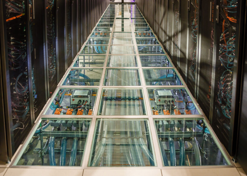 water rushes through tubes and computer racks, cooling the data center system at Sandia Labs