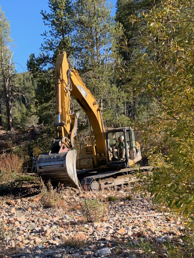 excavator digging into a rocky surface