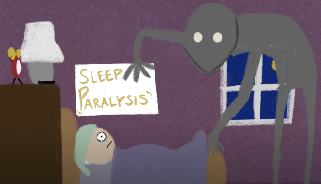 person in bed with sleep paralysis hallucination at their feet