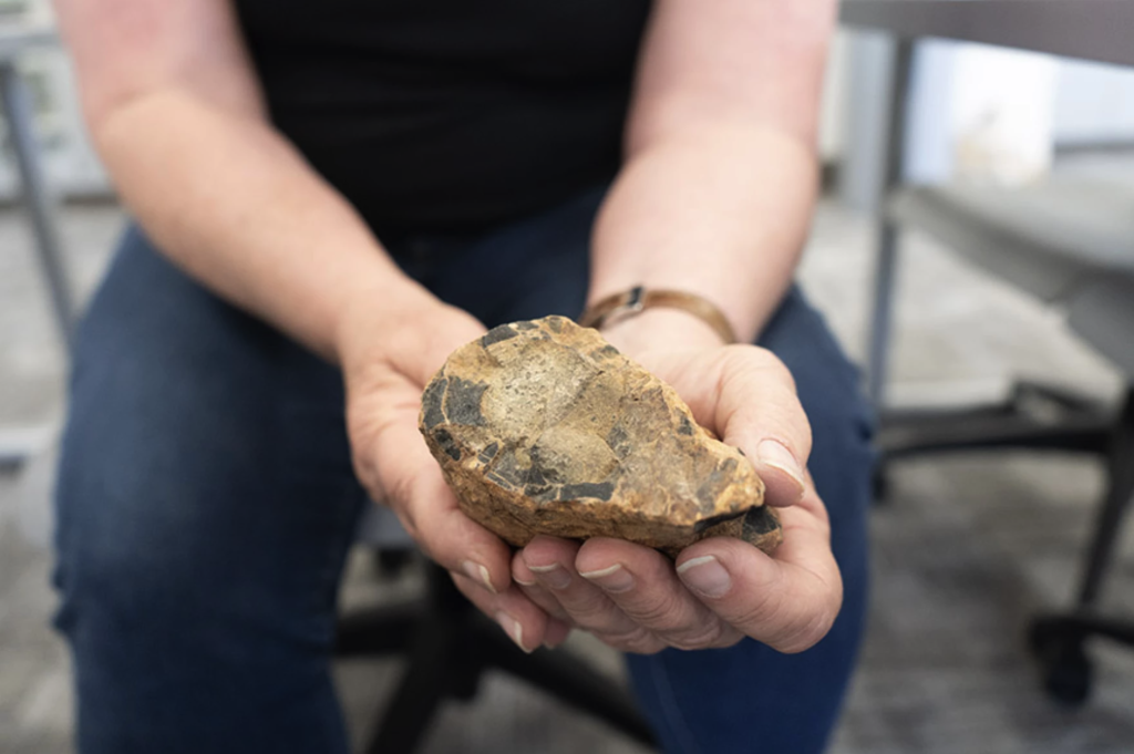 Dr. Kortemeier holds a rock sample