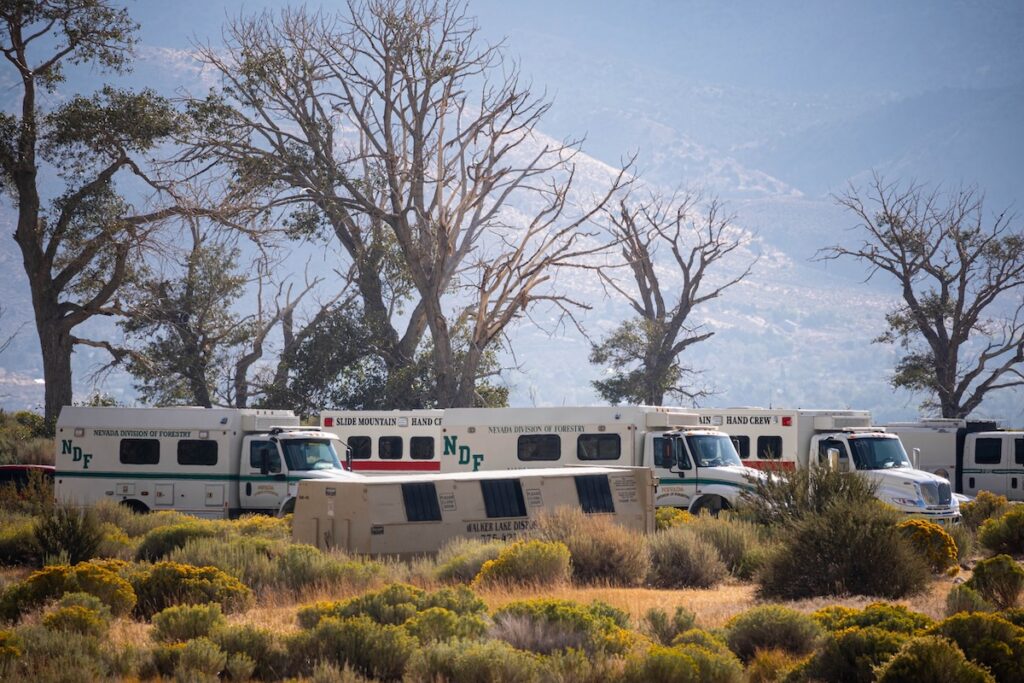 Makeshift parking lot for crew vehicles in a sheep field