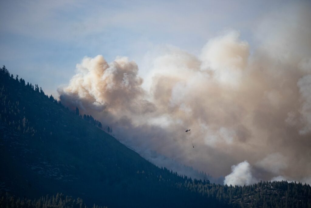 Helicopter dropping water from Washoe Lake on unseen flames