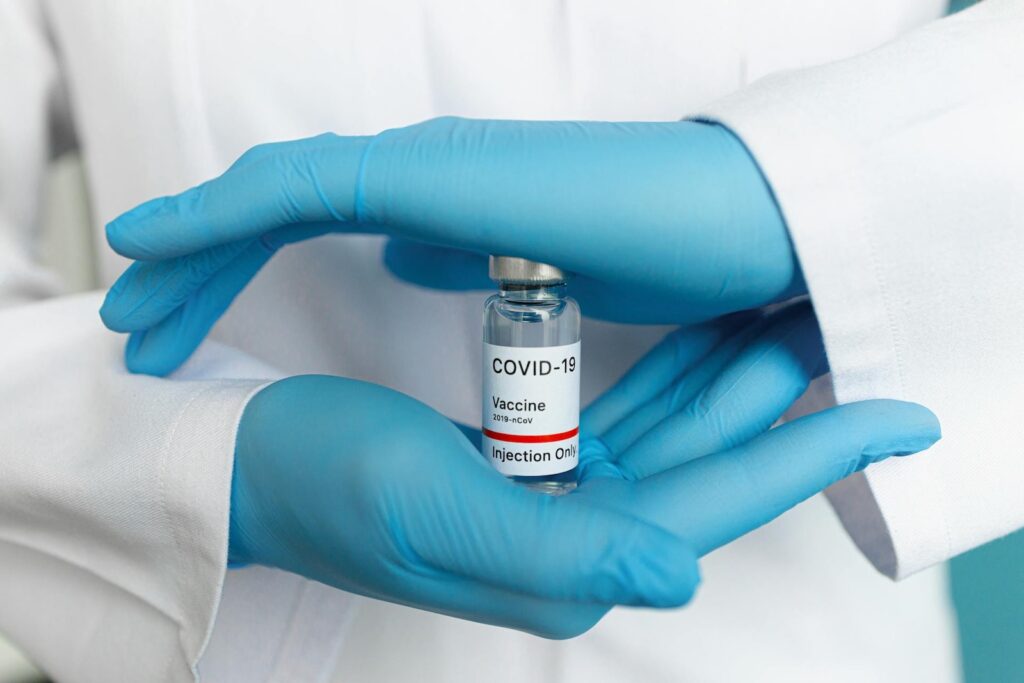 hands holding covid vaccine bottle