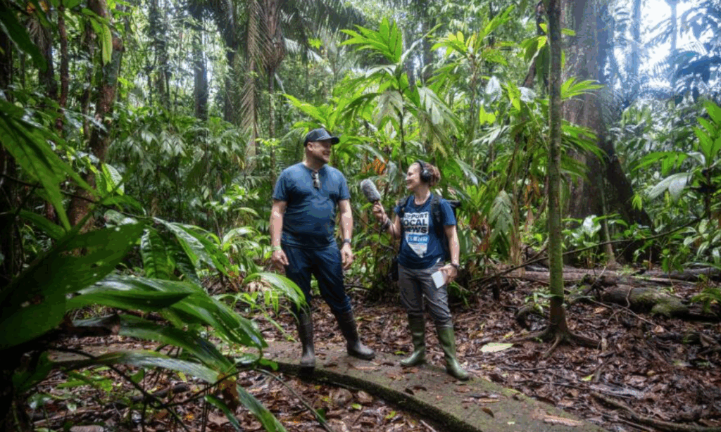 A reporter interviews a researcher in the jungle in Costa Rica