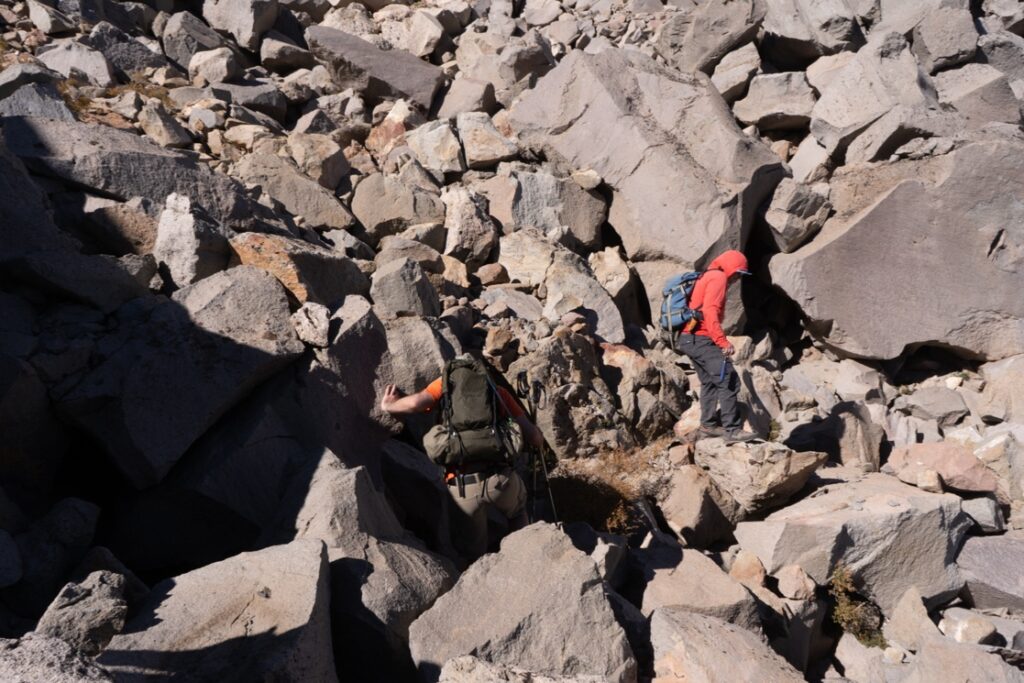 The research team crosses a boulder field at Lassen Volcanic National Park.